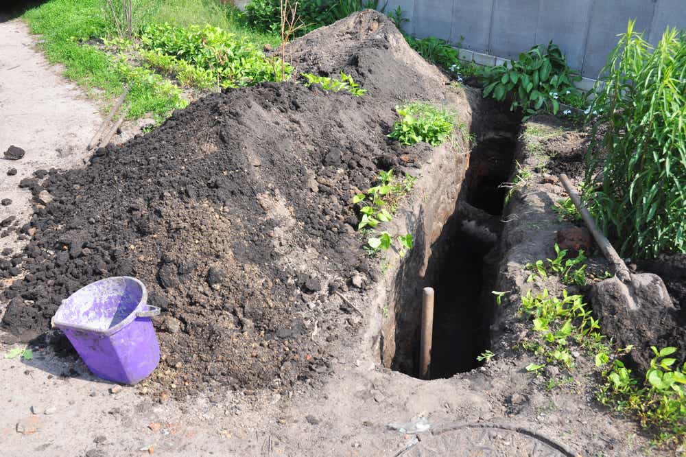 Digging a trench. Earthworks, digging trench. Long earthen trench dug to lay pipe.