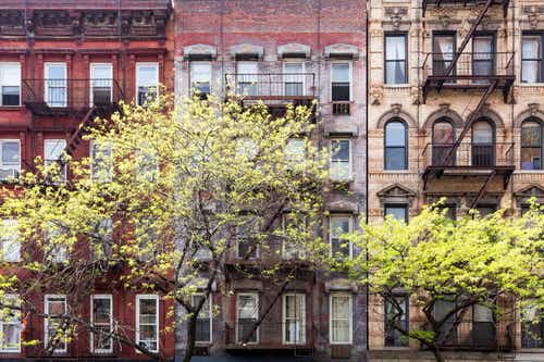 Historic old buildings and trees along 3rd Avenue in the East Village of Manhattan, New York City NYC